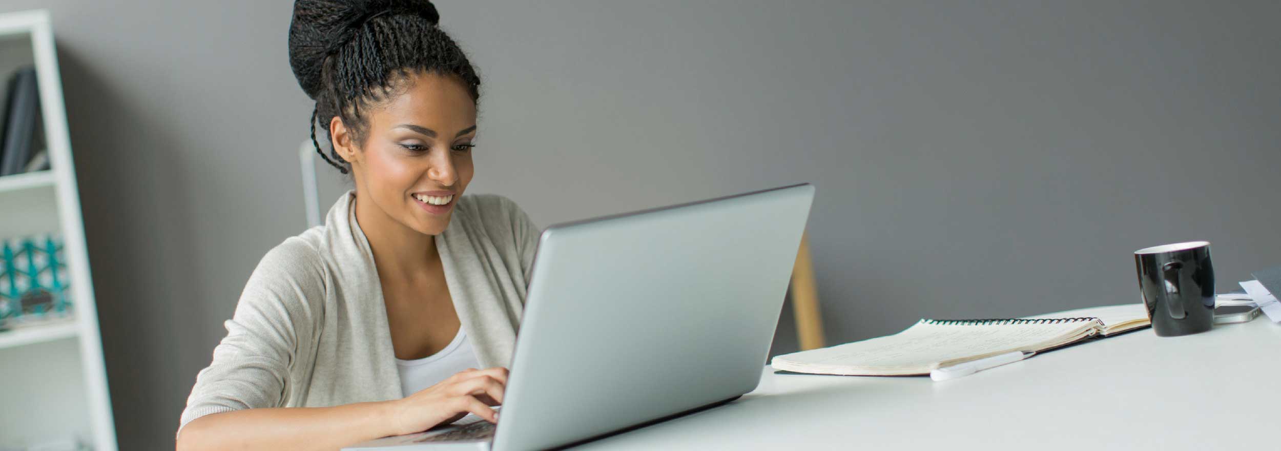 Man at desk smiling at laptop